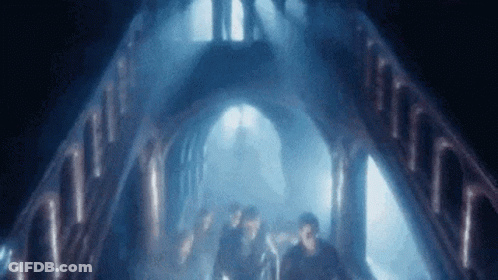 People Walking In Dark Tunnel With Blue Light GIF