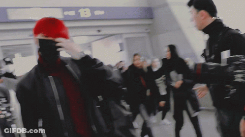 People Walking In Front Of B Sign GIF