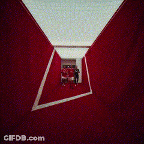 People Walking In Hallway With Coca Cola Mural GIF