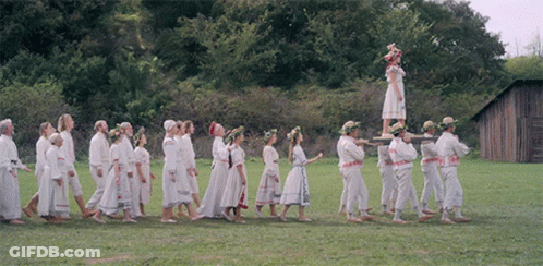 People Walking In Line With Woman On Pole GIF