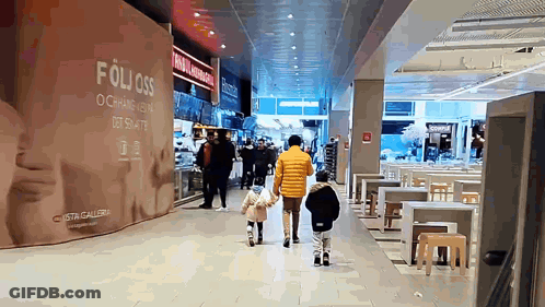 People Walking In Mall With Folioss Sign GIF