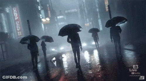 People Walking In Rain With Umbrellas In Front Of E3 Live Sign GIF