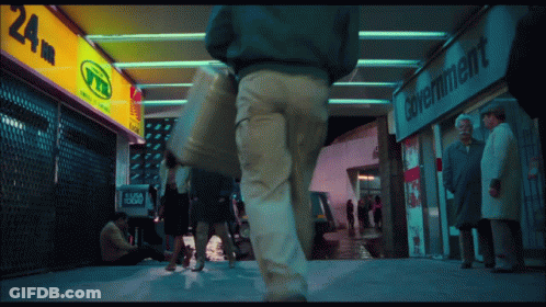 People Walking Past Government Store GIF
