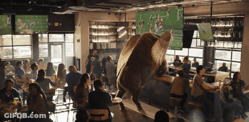People Watching Football In Restaurant GIF