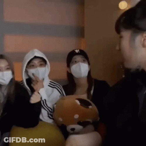 People Wearing Face Masks Standing Together GIF
