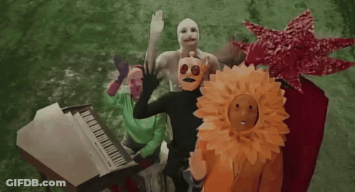 People Wearing Masks Around White Piano GIF