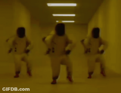 People Wearing Masks In Hallway GIF