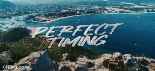Perfect Timing Is Written On A Rocky Hill Overlooking The Ocean GIF