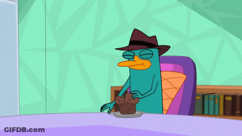 Perry The Platypus Sitting At Table GIF