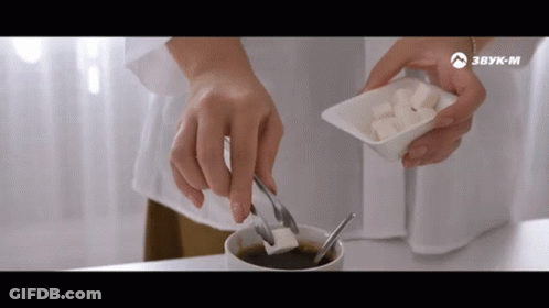 Person Adding Sugar To Coffee With Tongs GIF
