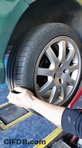 Person Adjusting Tire With Peugeot Logo GIF