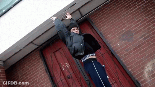 Person At Brick Building Number 38 GIF