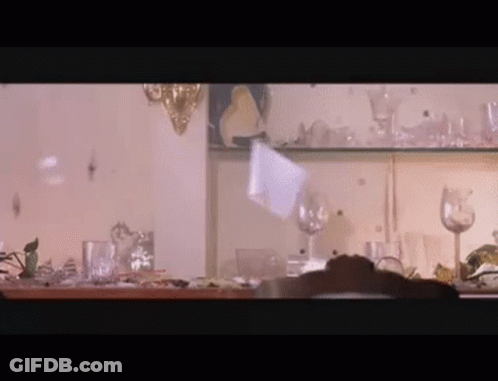 Person At Shelf Full Of Glasses And Plates GIF