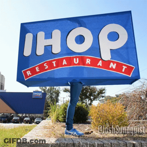 Person Behind Blue Ihop Restaurant Sign GIF