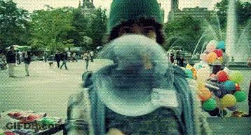 Person Blowing Bubble Gum By Fountain GIF