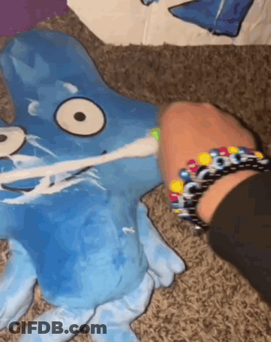 Person Brushing Stuffed Animal With Toothbrush GIF