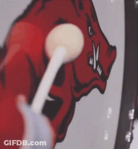 Person Brushing Teeth In Front Of Drawing Of A Boar GIF