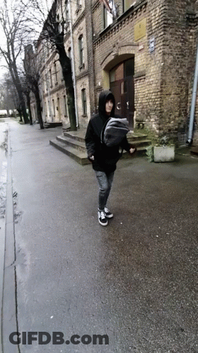 Person Carrying Baby In Sling On Street GIF