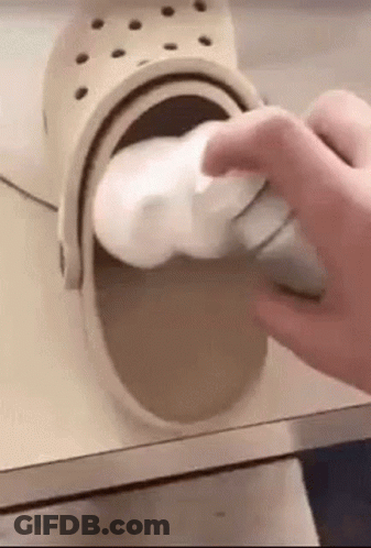 Person Cleaning Crocs With Foam GIF