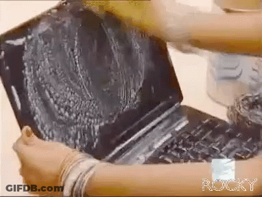 Person Cleaning Laptop With Rocky On Wrist GIF