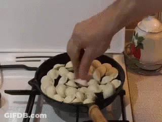 Person Cooking Food In Pan On Stove GIF