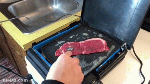 Person Cooking Steak On Grill GIF