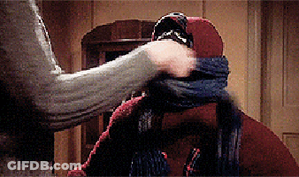 Person Covering Another's Mouth With Scarf GIF