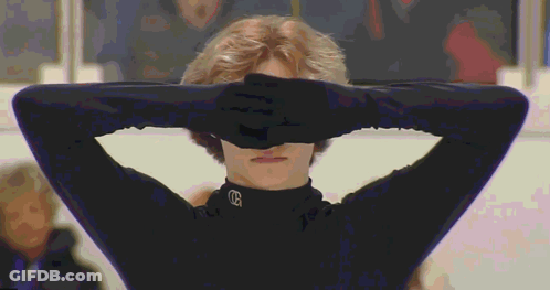 Person Covering Eyes In Black Shirt With Letter G GIF