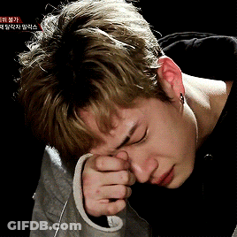 Person Covering Face With Hand And Chinese Writing GIF