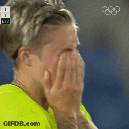 Person Covering Face With Hands Olympics Logo Behind GIF