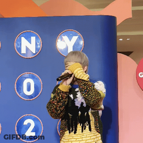 Person Covering Face With Microphone GIF