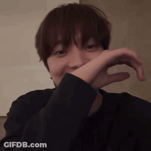 Person Covering Mouth In Dark Room GIF
