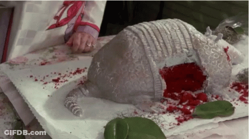 Person Cutting Armadillo Cake With Blood GIF