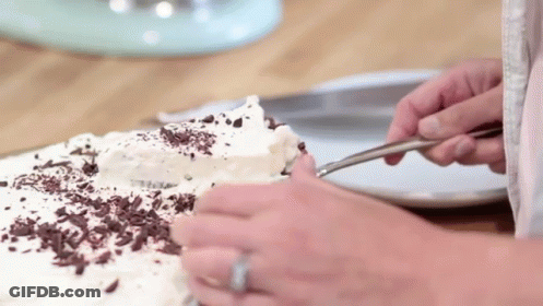 Person Cutting Cake With Chocolate Shavings GIF