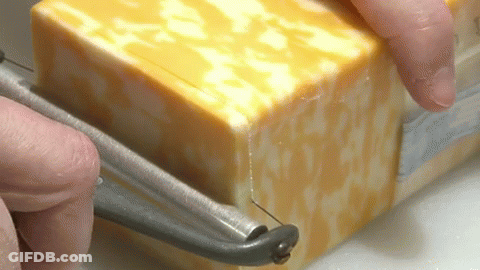 Person Cutting Cheese With Knife GIF
