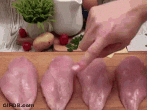 Person Cutting Chicken Breasts On Cutting Board GIF