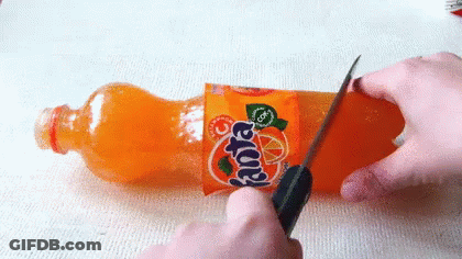 Person Cutting Fanta Bottle With Knife GIF