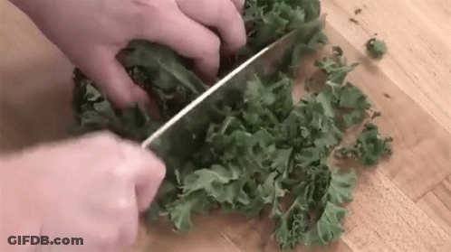 Person Cutting Kale With Knife GIF