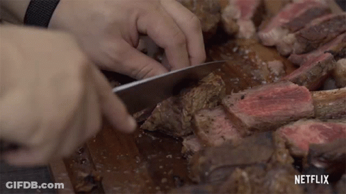 Person Cutting Large Piece Of Meat With Netflix GIF