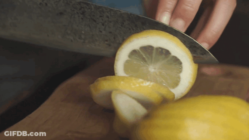 Person Cutting Lemon With Knife GIF