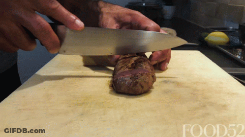 Person Cutting Meat On Cutting Board With Food52 GIF