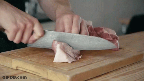 Person Cutting Meat On Cutting Board With Knife GIF