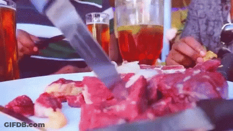 Person Cutting Meat On Plate GIF