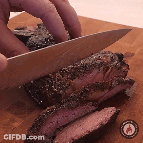 Person Cutting Meat On Wooden Board GIF