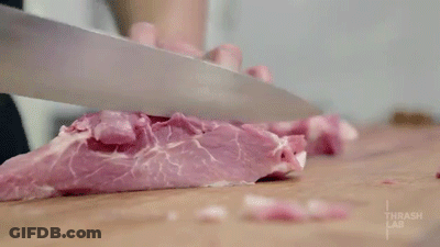 Person Cutting Meat With Thrash Lab GIF