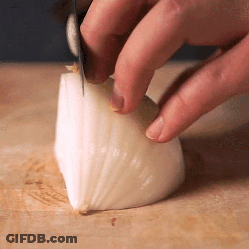 Person Cutting Onion With Knife GIF