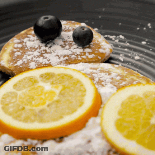 Person Cutting Pancake On Wooden Board GIF
