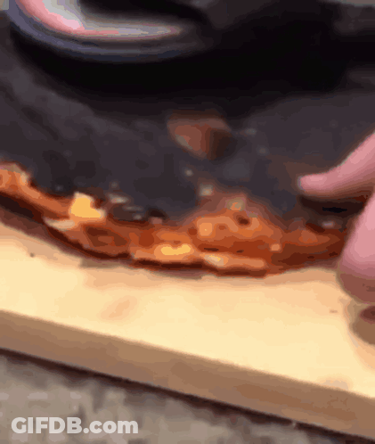 Person Cutting Pizza With Knife GIF