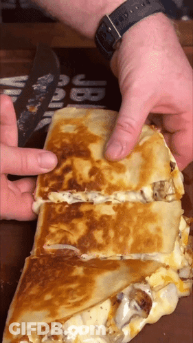Person Cutting Quesadilla In Half GIF