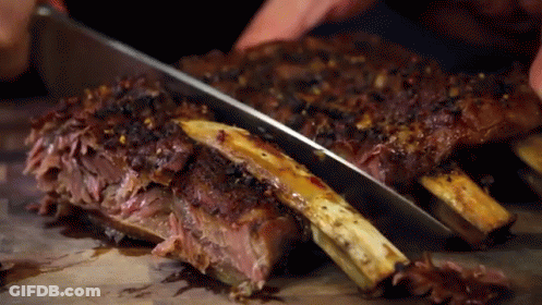Person Cutting Ribs With Knife GIF